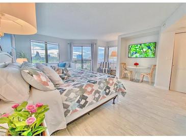 Main bedroom with a king-size bed and city views at 6165 Carrier Dr # 3707, Orlando, FL 32819