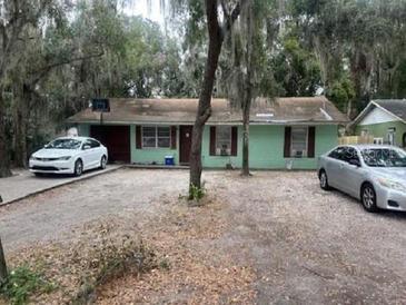 Ranch-style home with carport and mature landscaping at 745 E Jackson Ave, Mount Dora, FL 32757