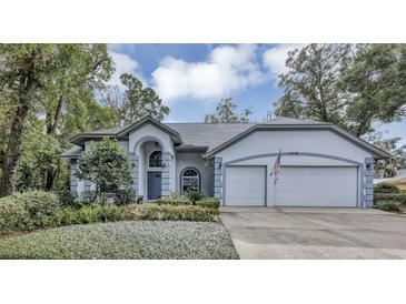 Two-story house with a two car garage and landscaped front yard at 2376 Park Village Pl, Apopka, FL 32712