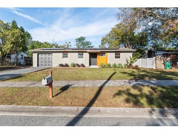 Updated ranch home with modern facade, landscaped lawn, and driveway at 130 N Fairfax Ave, Winter Springs, FL 32708