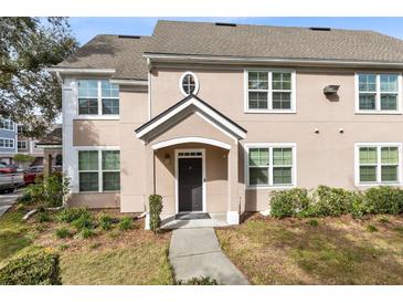 Two-story townhome with a welcoming front porch and landscaping at 3433 Soho St # 204, Orlando, FL 32835