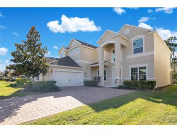 Two-story house with a large driveway and landscaped lawn at 8298 Lookout Pointe Dr, Windermere, FL 34786