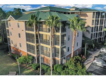 Attractive condo building with palm trees and ample parking at 9051 Treasure Trove Ln # 301, Kissimmee, FL 34747