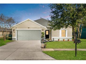 Charming single-story home features a manicured lawn, two car garage, and covered entry at 164 Pergola Pl, Ormond Beach, FL 32174