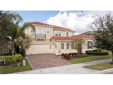 Two-story house with tile roof, large driveway, and landscaping at 16767 Rusty Anchor Rd, Winter Garden, FL 34787