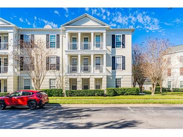 Three-story condo building with traditional architecture and balconies at 231 Goldenrain Dr # 4304, Celebration, FL 34747