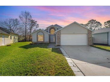 Two-story house with a large yard and attached garage at 3846 Long Grove Ln, Port Orange, FL 32129