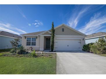 One-story home with a two-car garage and landscaped lawn at 613 Greymount St, Davenport, FL 33837