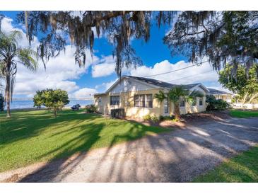 Ranch style home with lake view, mature trees, and spacious yard at 9000 Ogilvie Dr, Orlando, FL 32819