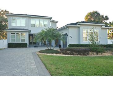 Two-story house with gray siding, paver driveway, and landscaping at 216 Magnolia St, Windermere, FL 34786