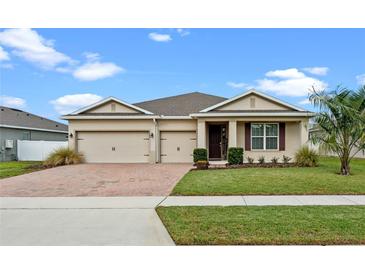 Attractive single-story home with two-car garage and landscaped yard at 2249 Palmetum Loop, Apopka, FL 32712