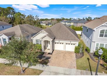 Attractive single-story house with a two-car garage and brick driveway, nestled in a quiet community at 4838 Southlawn Ave, Orlando, FL 32811