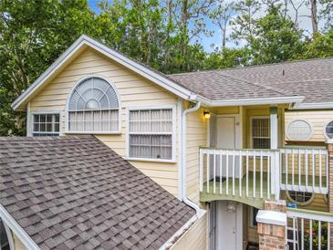 Charming condo featuring an arched window, balcony, and neutral paint scheme at 5003 Laguna Bay Cir # 16, Kissimmee, FL 34746