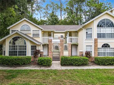 Charming condo building with a two story facade, well-manicured landscaping, and large arched windows at 5003 Laguna Bay Cir # 16, Kissimmee, FL 34746