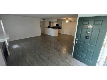 Bright living room with tile floors, fireplace, and access to patio at 5587 Devonbriar Way # 104, Orlando, FL 32822