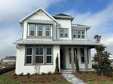 Beautiful two-story home featuring a modern farmhouse facade, landscaped yard and inviting walkway at 9819 Gobat Aly, Orlando, FL 32827