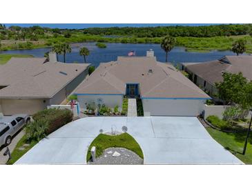 Charming single-story home with a well-manicured front yard and a driveway leading to an attached garage, near lake at 1433 Lake Marion Dr, Apopka, FL 32712