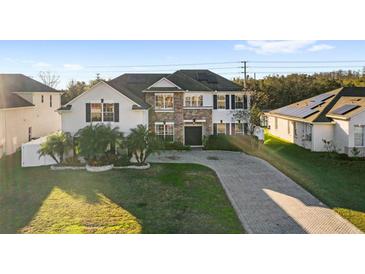 Two-story home with stone accents and landscaped yard at 2630 Eagle Meadow Lane, Kissimmee, FL 34746