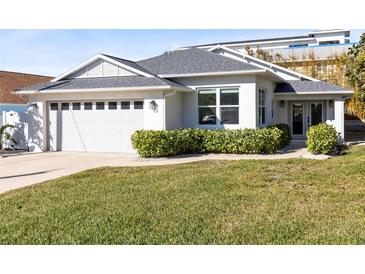 Newly built home with gray roof, white walls, and a two-car garage at 830 Hope Ave, New Smyrna Beach, FL 32169