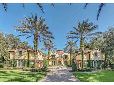 Grand two-story home with gated entry and lush landscaping at 1120 Preserve Point Dr, Winter Park, FL 32789