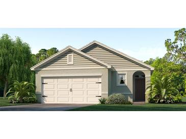 One-story home with a gable roof, attached garage, and landscaped lawn at 7079 Carib Grackle Dr, Saint Cloud, FL 34773