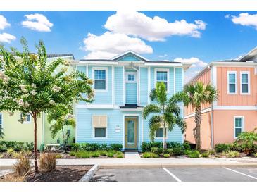 Two-story light blue house with a landscaped yard at 8019 Knee Deep Rd, Kissimmee, FL 34747