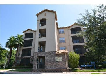 Exterior view of a multi-story building with stone accents at 1351 Tuscan Ter # 8401, Davenport, FL 33896