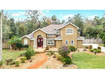 Two-story house with landscaped yard and walkway at 1437 Pecos Dr, Ormond Beach, FL 32174