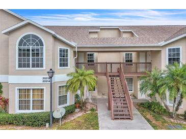Two-story condo building with stairs and balconies at 2321 Prime Cir # B, Kissimmee, FL 34746