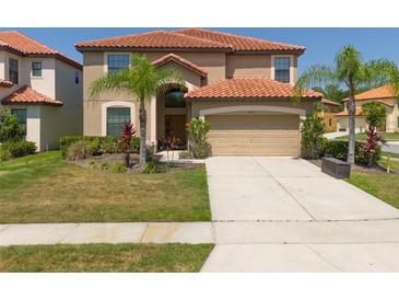 Two-story house with a large driveway and landscaped yard at 2641 Tranquility Way, Kissimmee, FL 34746