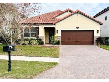 One-story home with brown garage door and brick accents at 273 Ancona Ave, Debary, FL 32713