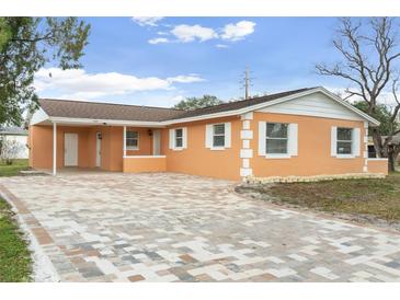 Updated single story home with new paint, landscaping, and a brick driveway at 4403 Brooke St, Orlando, FL 32811