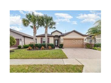 Single-Gathering home with a two-car garage and landscaped front yard at 672 Cordoba Dr, Davenport, FL 33837
