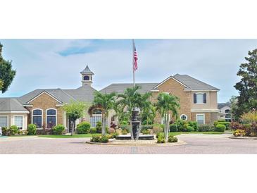 Elegant community clubhouse with fountain and landscaping at 940 Village Trl # 8-101, Port Orange, FL 32127