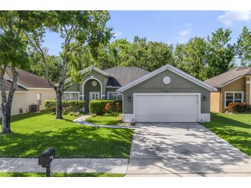 Charming single-story home with a well-maintained lawn and mature trees enhancing curb appeal at 2961 Cedar Glen Pl, Oviedo, FL 32765