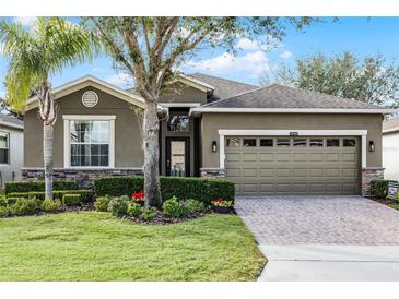 One-story house with a two-car garage and manicured lawn at 3649 Corsica Ln, Clermont, FL 34711
