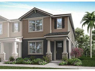 Two-story home with neutral siding, stone accents, and landscaping at 9863 Walkway Dr, Orlando, FL 32832