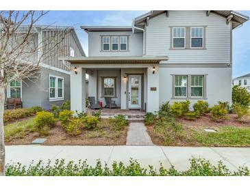 Two-story house with front porch and landscaping at 13384 Leggett Aly, Orlando, FL 32827