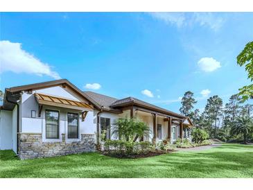 Single-story home with stone accents and a covered porch at 2647 Zuni Rd, St Cloud, FL 34771