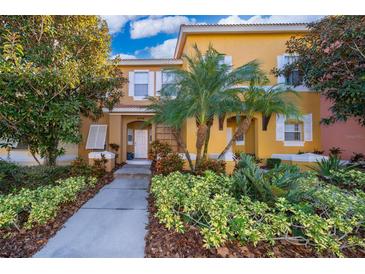 Inviting exterior of a two-story townhome with landscaping at 4706 Vero Beach Pl, Kissimmee, FL 34746
