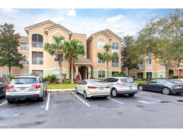 Condo building with parking lot and lush landscaping at 4881 Cypress Woods Dr # 3309, Orlando, FL 32811
