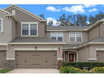 Two-story townhome with attached garage and landscaped front yard at 8426 Chamberlain Pl, Oviedo, FL 32765