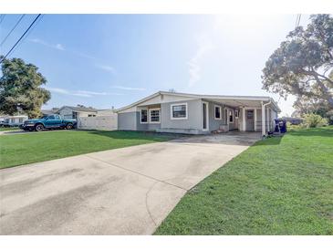 Gray house with a carport and a spacious yard at 1108 Evangeline Ave, Orlando, FL 32809