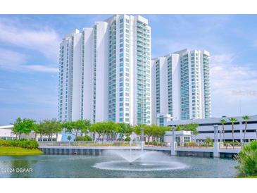 Luxury high-rise building with water fountain and landscaping at 241 Riverside Drive # 409, Daytona Beach, FL 32117