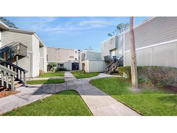 Community courtyard with walkways and landscaping at 273 Scottsdale Sq # 273, Winter Park, FL 32792