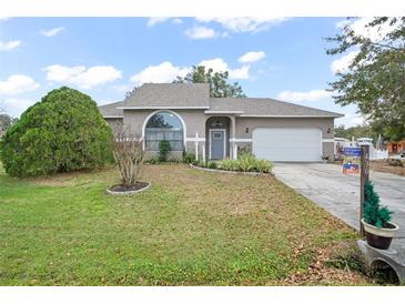 Charming one-story house with gray siding, a gray door, and a well-manicured lawn at 430 Magpie Ct, Kissimmee, FL 34759
