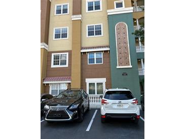 Building exterior with parking and landscaping at 8749 The Esplanade # 29, Orlando, FL 32836