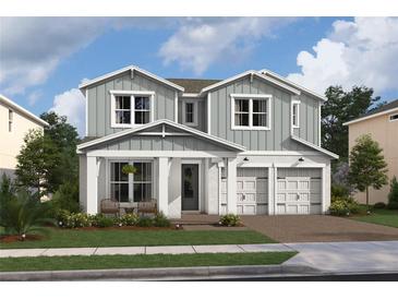 Two-story home with gray siding, white trim, and a two-car garage at 13106 Dendy Way # 19, Winter Garden, FL 34787