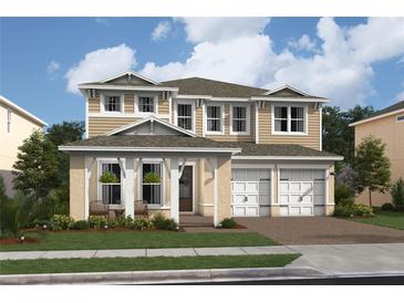 Two-story house with a beige exterior, two-car garage, and landscaping at 13171 Faro Ct # 31, Winter Garden, FL 34787