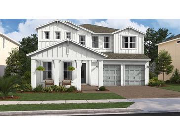 Two-story house with gray garage and white siding at 13188 Faro Ct # 42, Winter Garden, FL 34787
